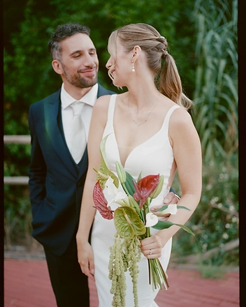Bride and groom in the garden holding the bridal bouquet