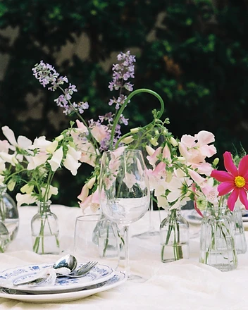 Full length garden table setup with wildflowers and blue china