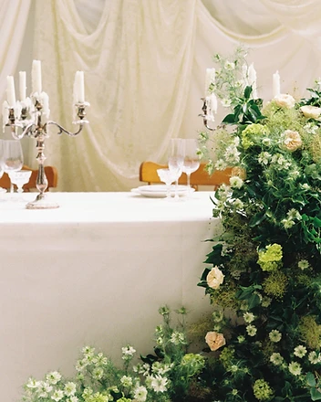 Close view of sweetheart table floral corner installation