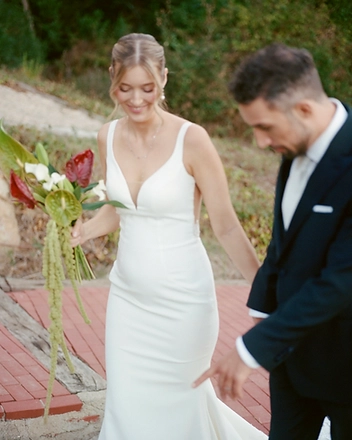 Bride and groom walking along the brick path