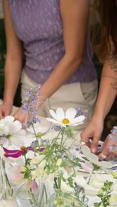 Florists arranging wildflower table centrepieces