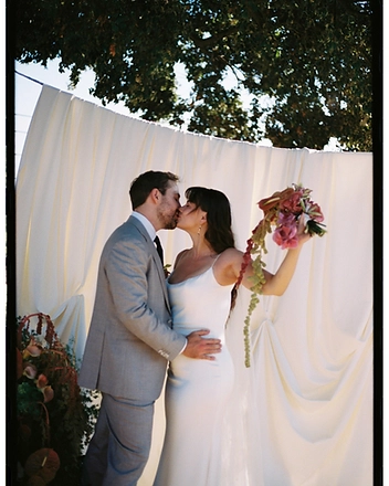 Bride and groom kissing in the afternoon light