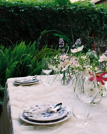 Garden table with pink and white wildflower arrangements