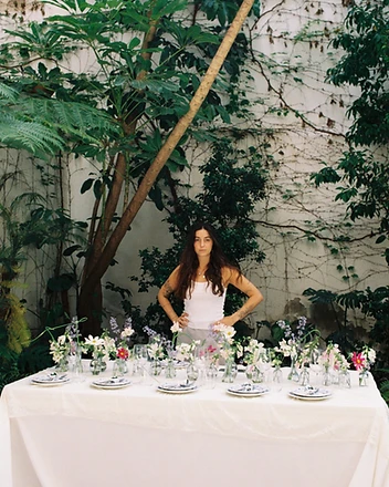 Towering white hydrangea installation beside silver candelabra