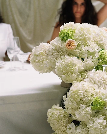 Candlelit hydrangea table installation at evening reception