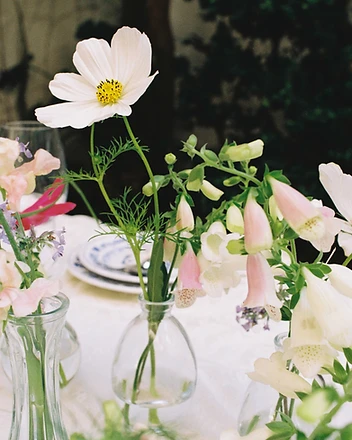 Florist inserting white hydrangea into floral foam