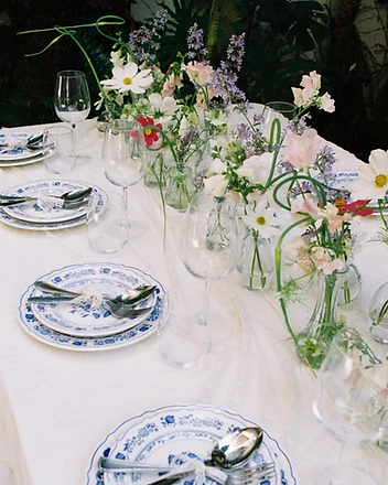 Hands placing hydrangeas into large cascading arrangement