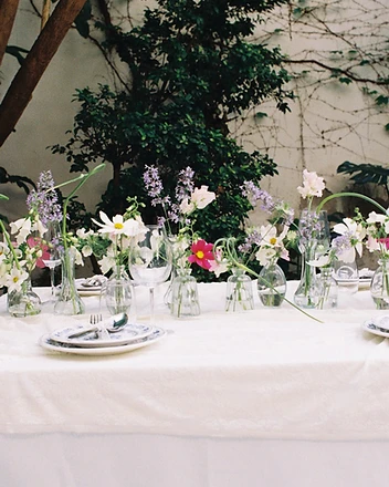 Overhead of garden table with blue-and-white plates and vases