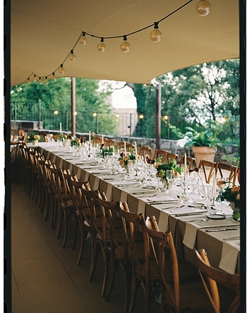 Reception table with cross-back chairs under the canopy
