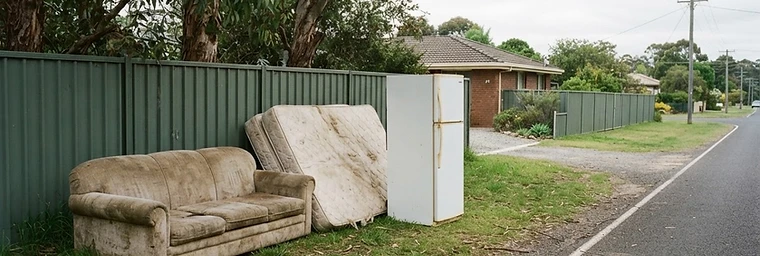 Old furniture and a retired appliance ready for collection outside a Wodonga home