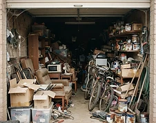A cluttered garage packed with junk before removal