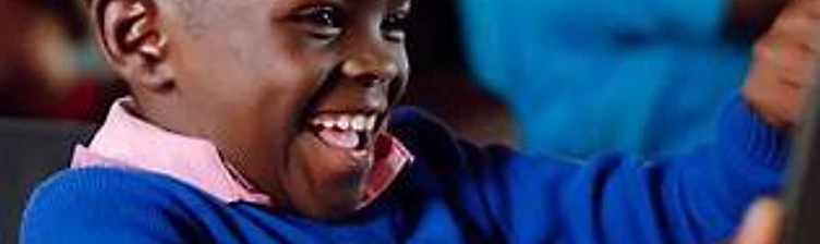 Joyful young Kenyan pupil in class, representing the learners at the centre of the programme