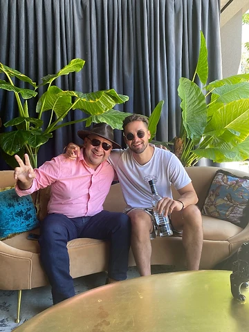 Two friends on a couch in Chile with tequila