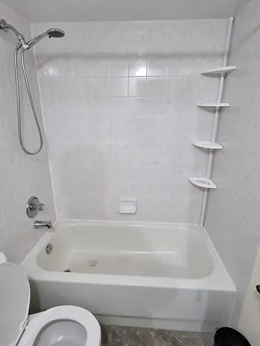 Existing bathtub and wall surround documented before a bathroom renovation