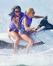 Clearwater Beach jet ski island tour — two women riding with a shaka gesture