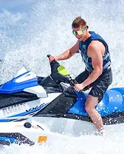Clearwater Beach jet ski island tour — rider with reflective sunglasses and a big splash