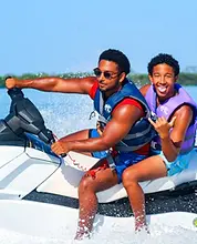 Clearwater Beach jet ski island tour — two men riding with a shaka gesture