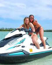 Clearwater Beach jet ski island tour — two women riding in shallow clear water