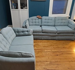 Two vintage blue tufted sofas