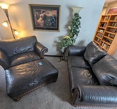 Two dark leather sofas with ottoman