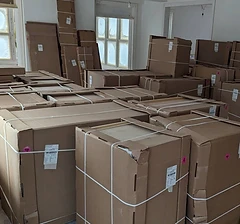 Room full of strapped and packaged furniture boxes