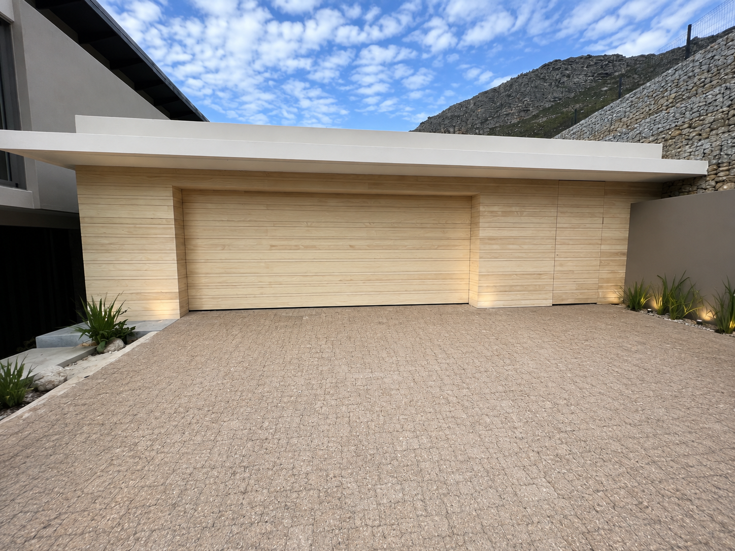 Modern timber-clad garage and driveway