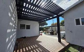 Louvered pergola over a hedge-lined Culver City yard