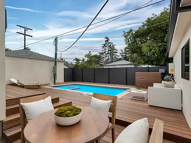 Natural wood vertical board backyard privacy fence — fence and gate installation by Fency Builders in Valley Village, Los Angeles.