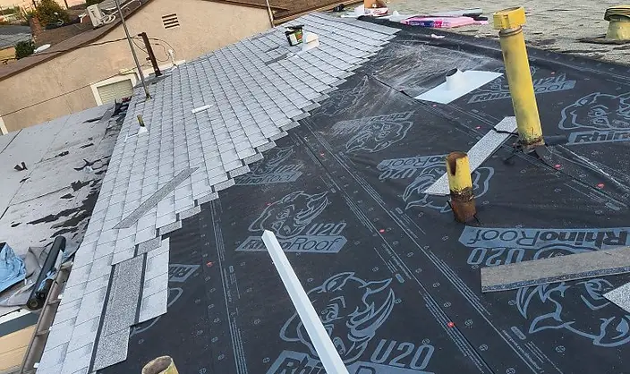 RhinoRoof underlayment with gray shingle installation underway