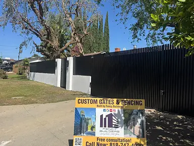 Black steel vertical slat fence with stucco base wall — fence and gate installation by Fency Builders in Hollywood, Los Angeles.