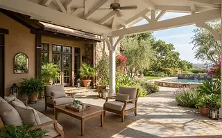 Editorial illustration: Attached solid-roof patio cover with white painted beams over a paver patio behind a California ranch home