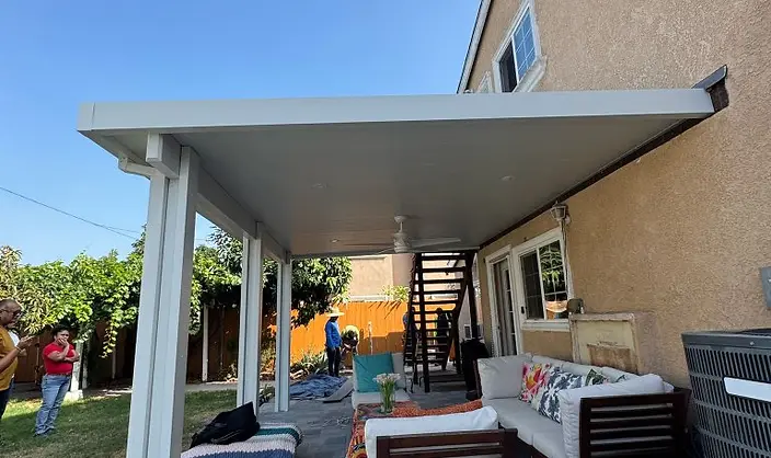 Solid white patio cover over paver patio
