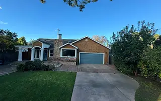Cedar shingle home exterior with arched portico in Valley Village