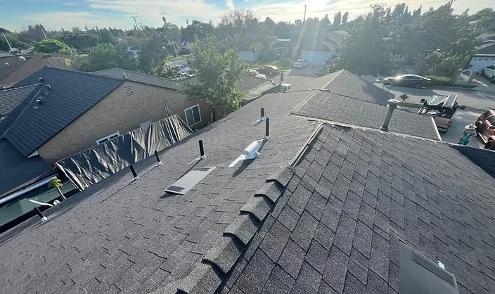 Finished shingle roof with ridge caps and vents