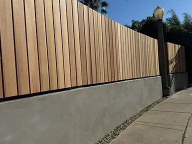 Powder-coated steel driveway gate with vertical slats — fence and gate installation by Fency Builders in Hollywood, Los Angeles.