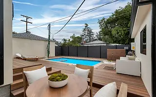 Pool deck and dark privacy fence at a Valley Glen home