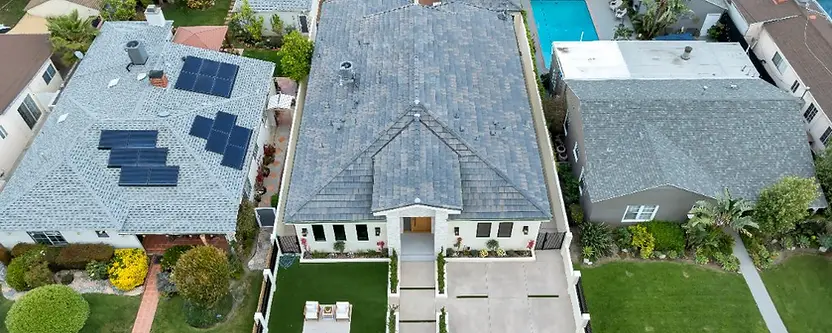 Aerial view of a completed Valley Glen home, roof, driveway, yard and fence
