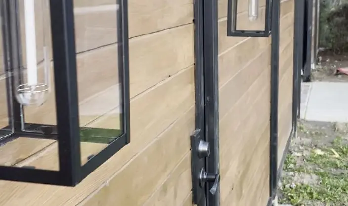 Modern wood-slat gate in a black steel frame