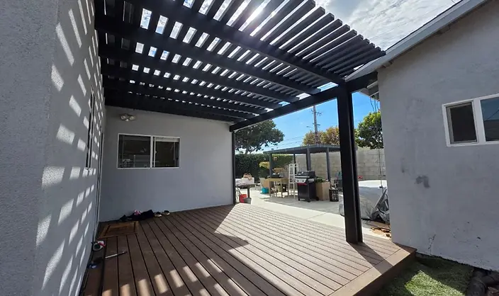 Black aluminum pergola over composite deck