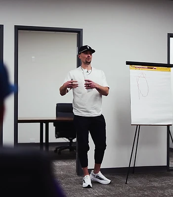 Fortis coach presenting to a group of athletes