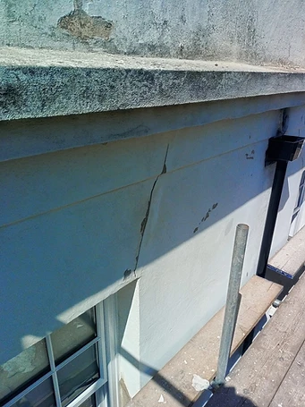 Render cracking at cornice — separation of facing coat from substrate