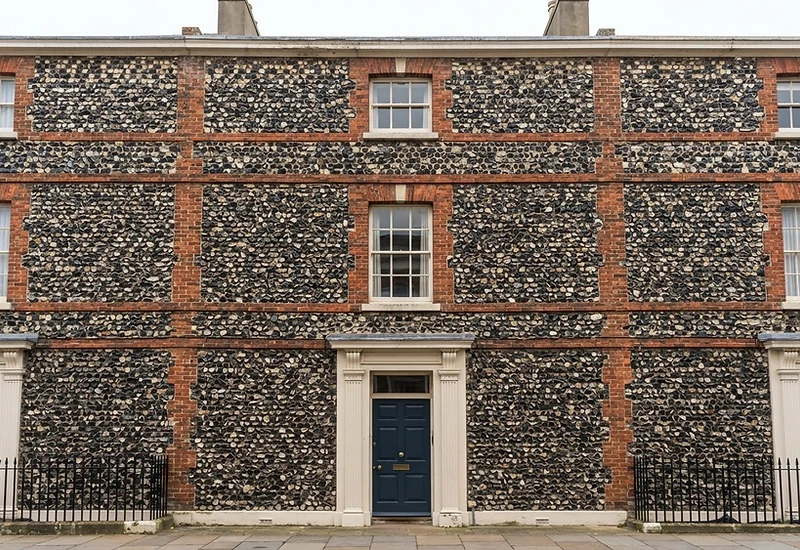 Close-up of a bungaroosh wall showing flint, brick and lime mortar