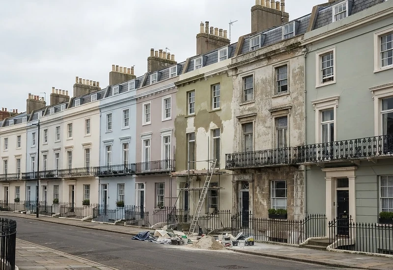 Regency terrace in Brighton with one elevation freshly patched in lime render