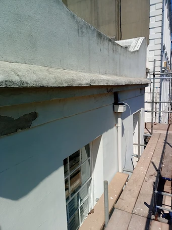 Structural cracking in render — full-height crack propagating from ground