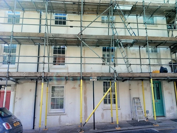 Parapet wall — render cracking and biological growth at coping