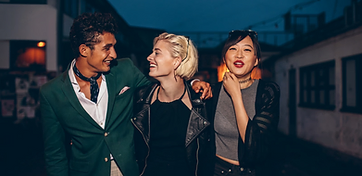 Friends walking together at night in the city