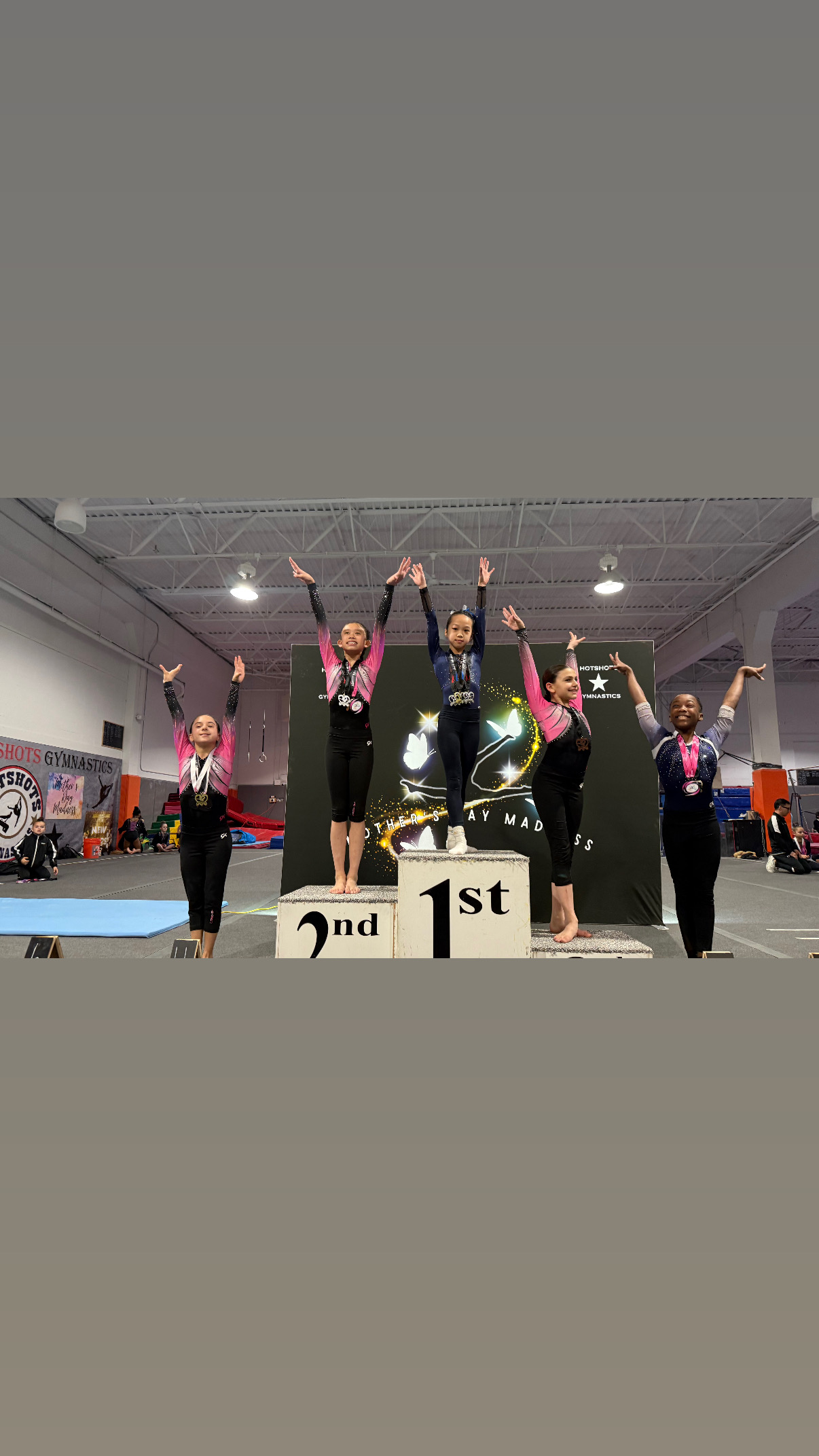 Gymnast holding trophy at competition handstand contest