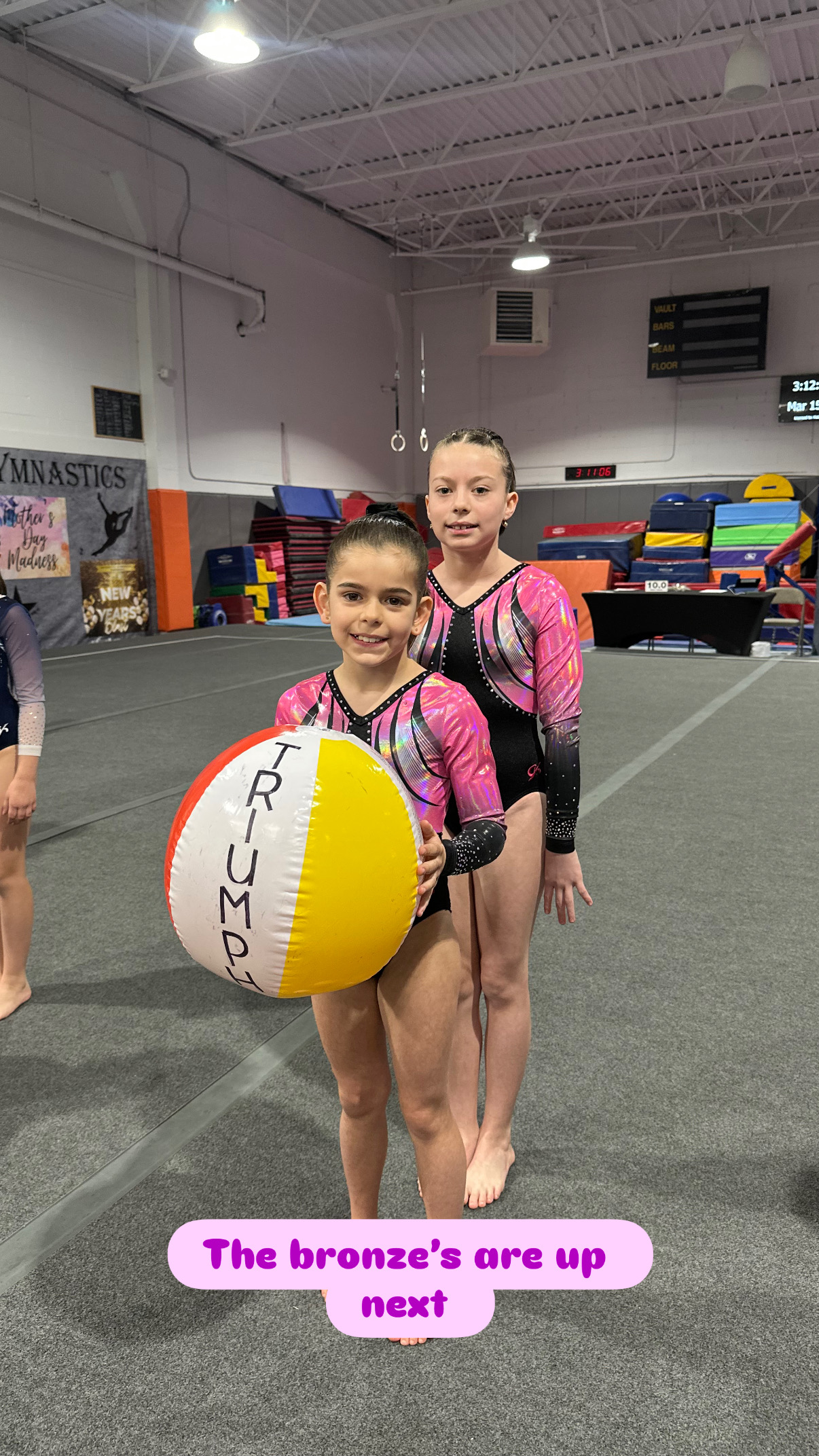 Gymnasts carrying Triumph team sign in competition parade