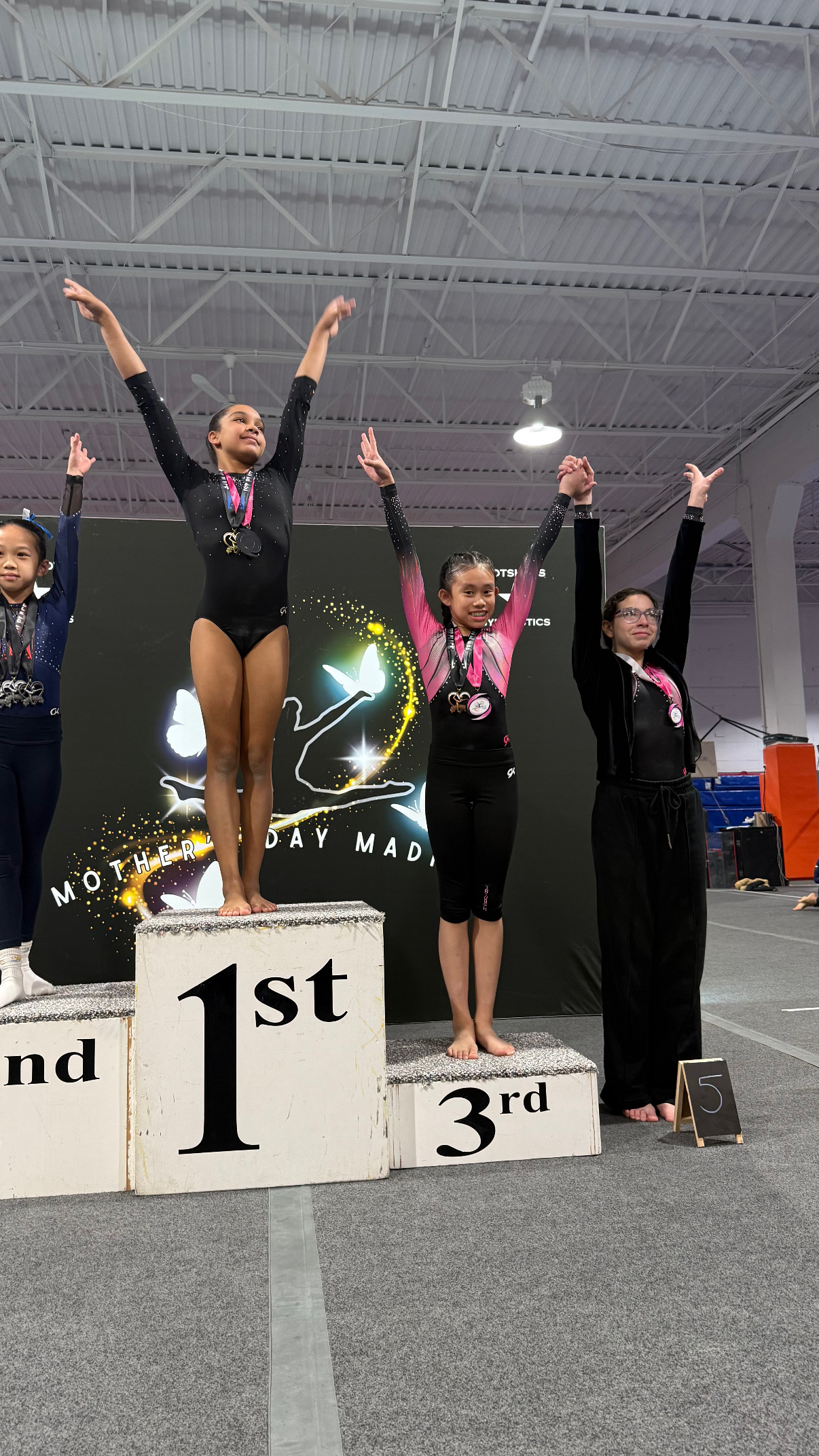 Gymnast in pink leotard performing floor routine at competition