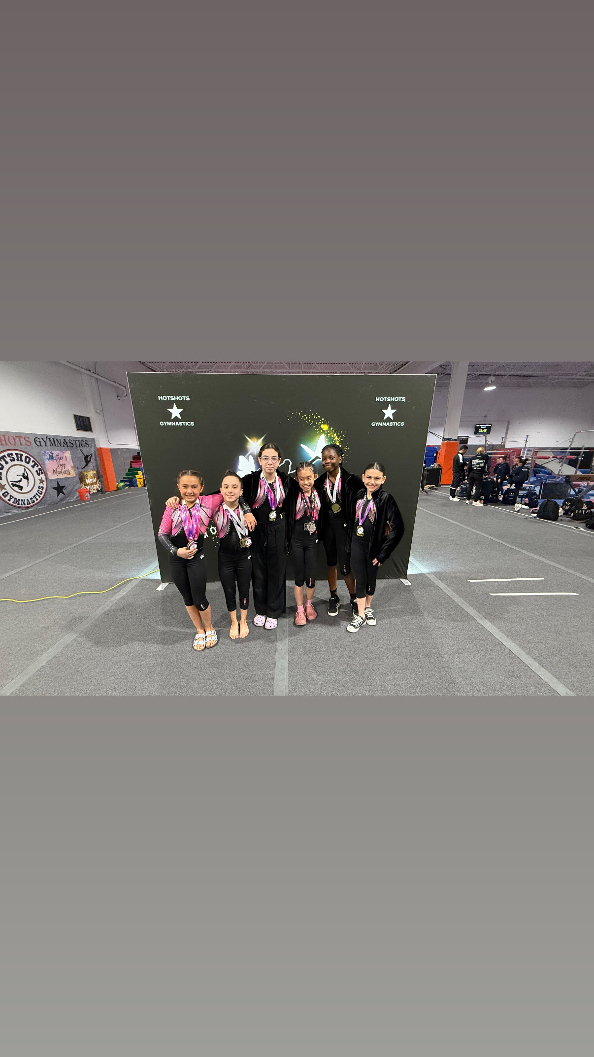 Collection of gymnastics competition medals on red background